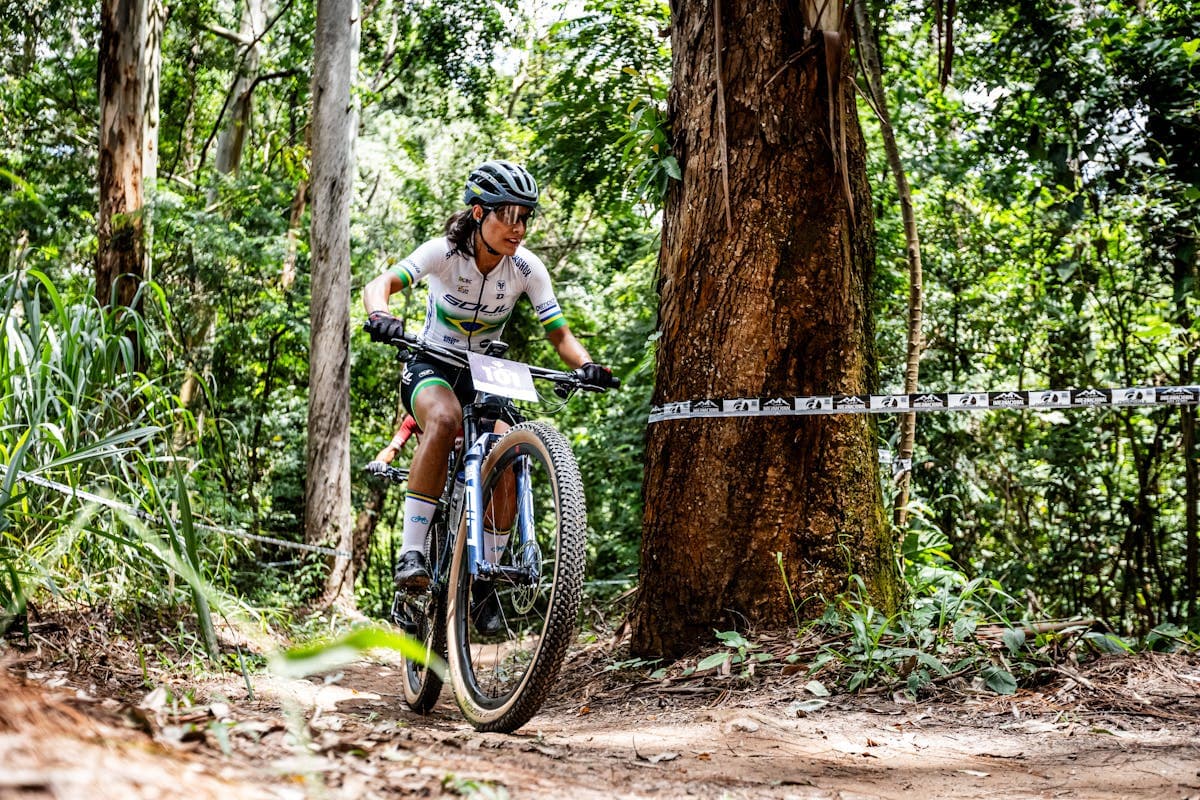 Mountain bikers racing through tropical forest trails during Brasil Ride in Bahia