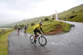 Cyclists riding through the misty Brecon Beacons mountains during the Dragon Ride sportive in Wales