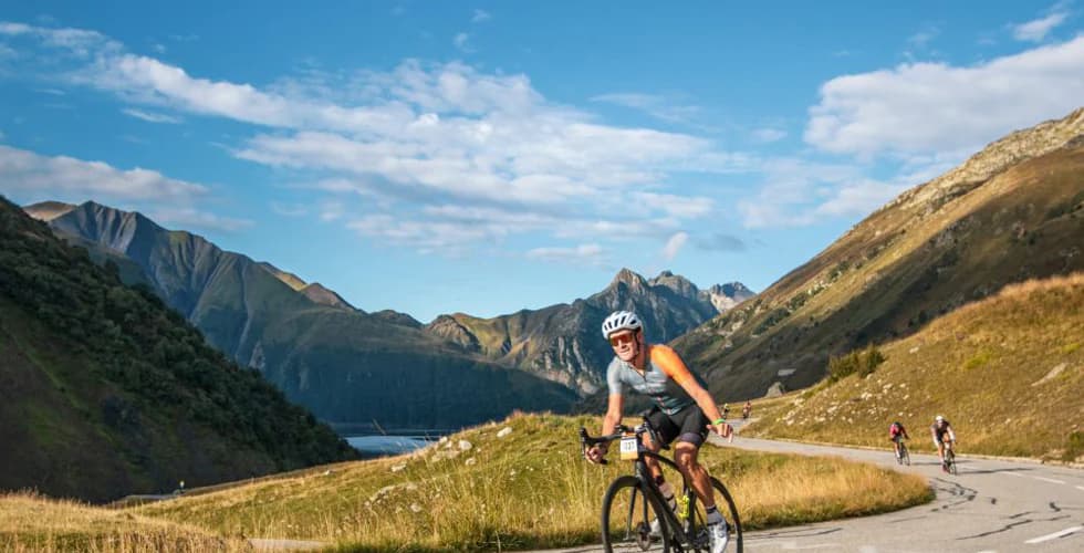 Cyclists climbing the switchbacks of Alpe d'Huez during La Marmotte gran fondo in the French Alps