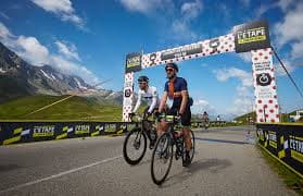 Thousands of amateur cyclists climbing an Alpine pass during L'Étape du Tour in France