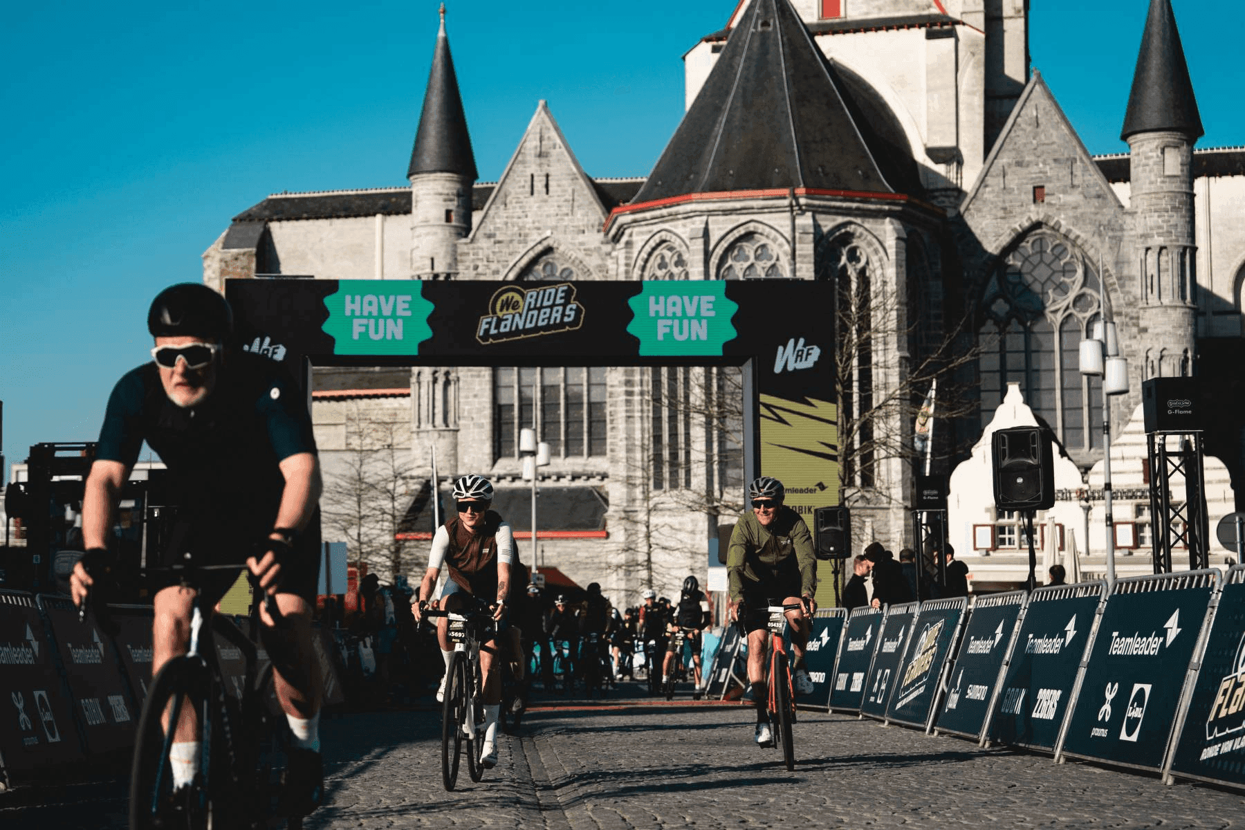 Cyclists tackling cobblestone climbs on the Tour of Flanders route during We Ride Flanders