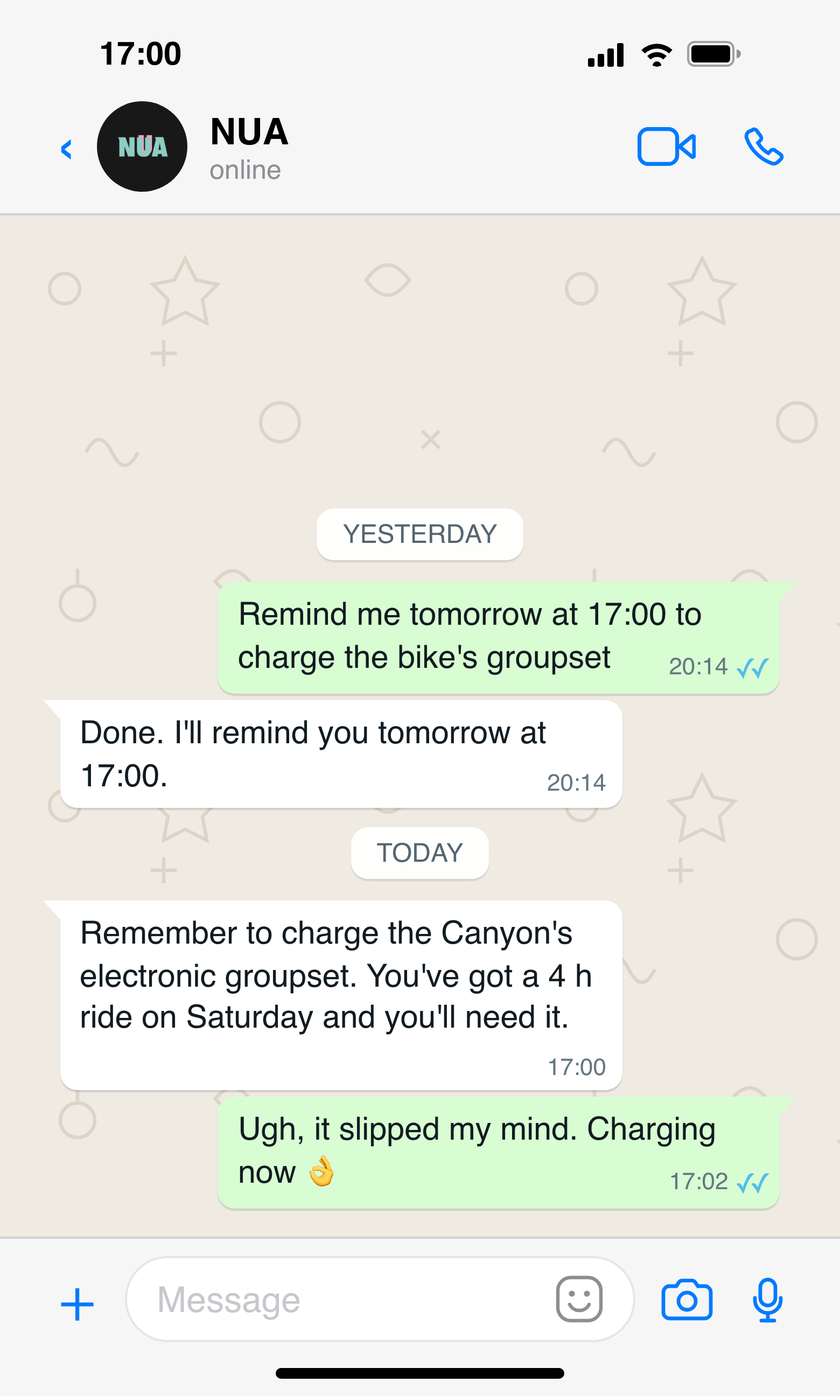 WhatsApp conversation in which the athlete asks NUA for a reminder to charge the bike's electronic groupset, and NUA reminds them the next day at the agreed time