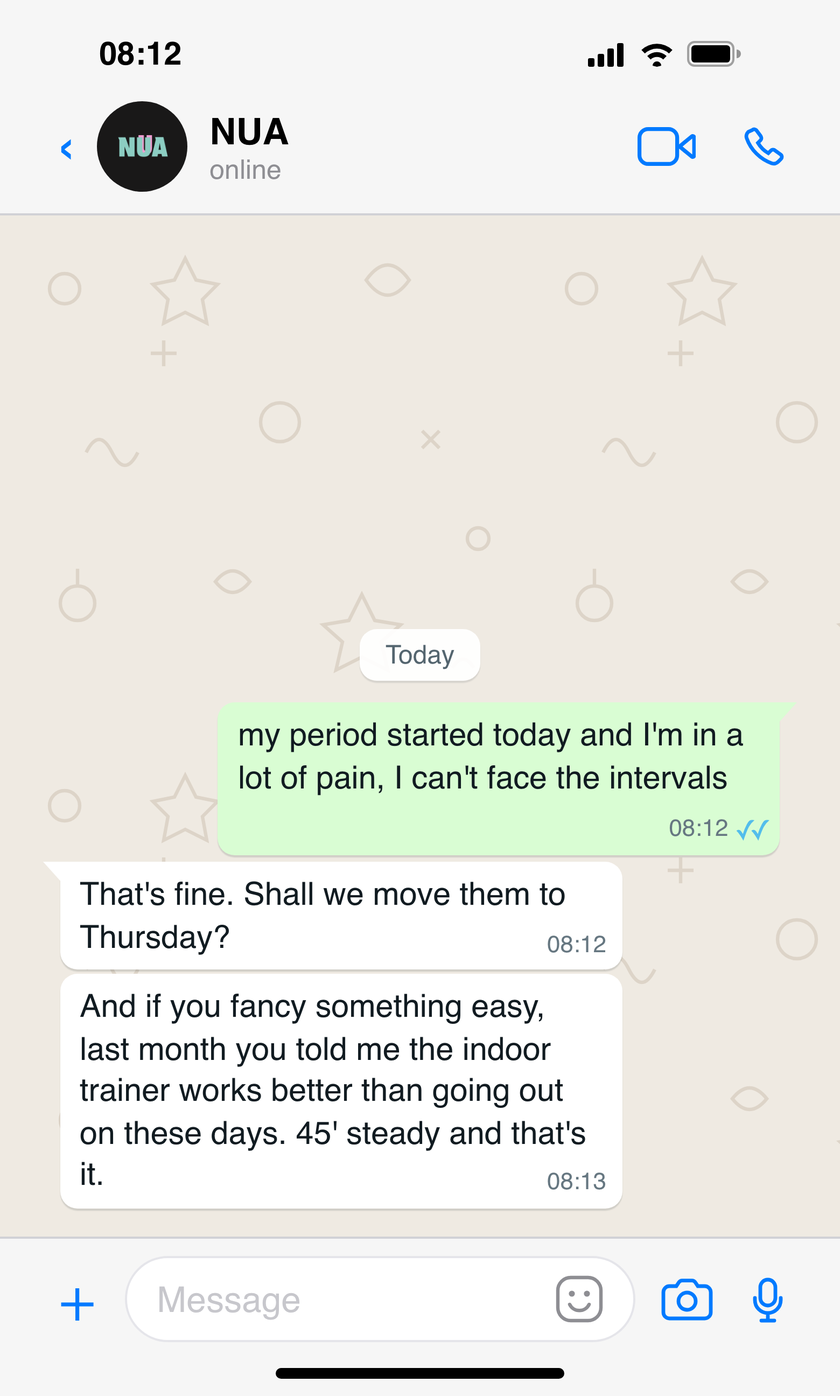 WhatsApp conversation where the athlete says her period has started and she's in pain, and NUA offers to move the intervals to Thursday and suggests an easy indoor trainer session, remembering what she had told it the month before